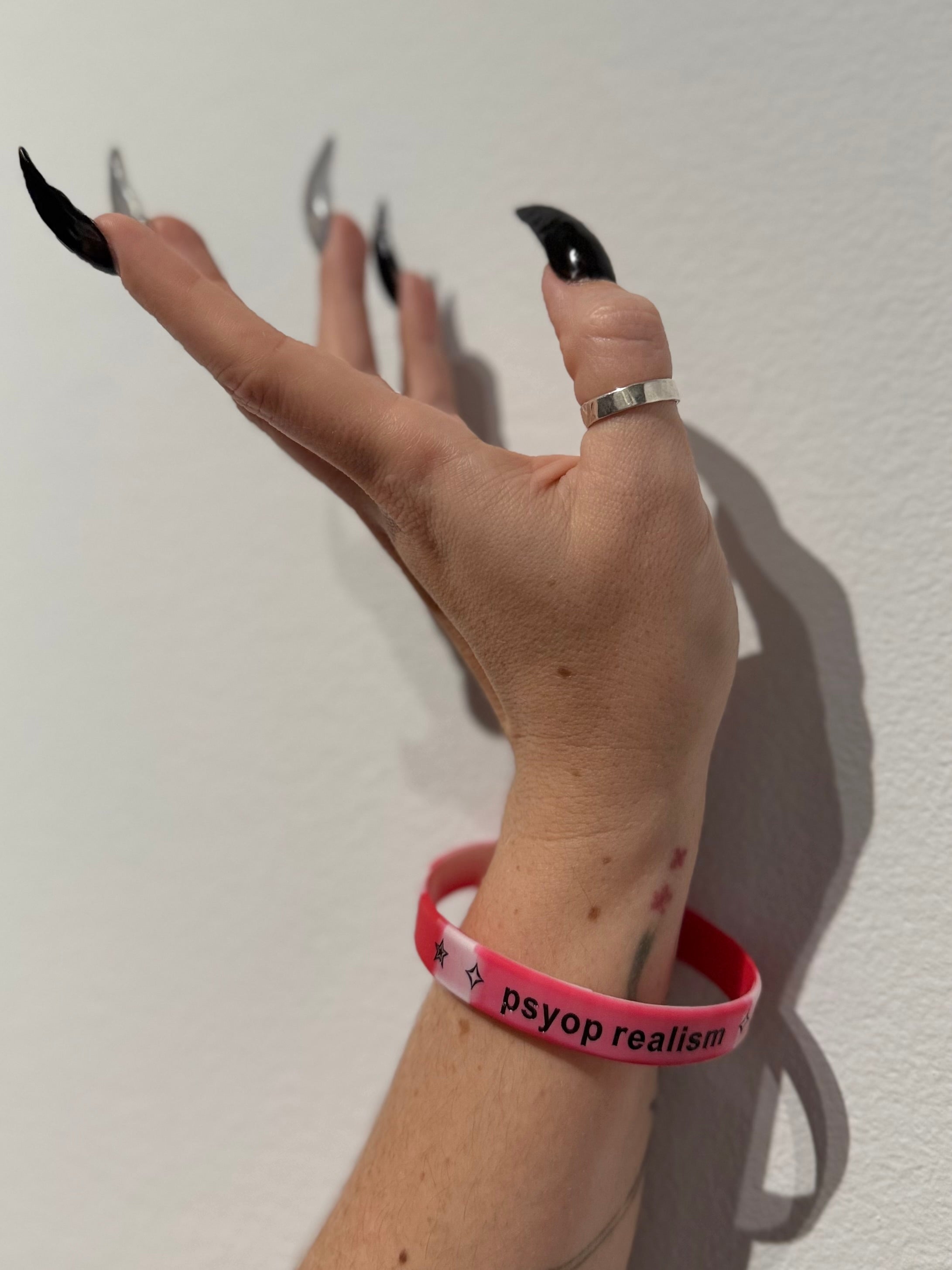 "psyop realism" red bracelets